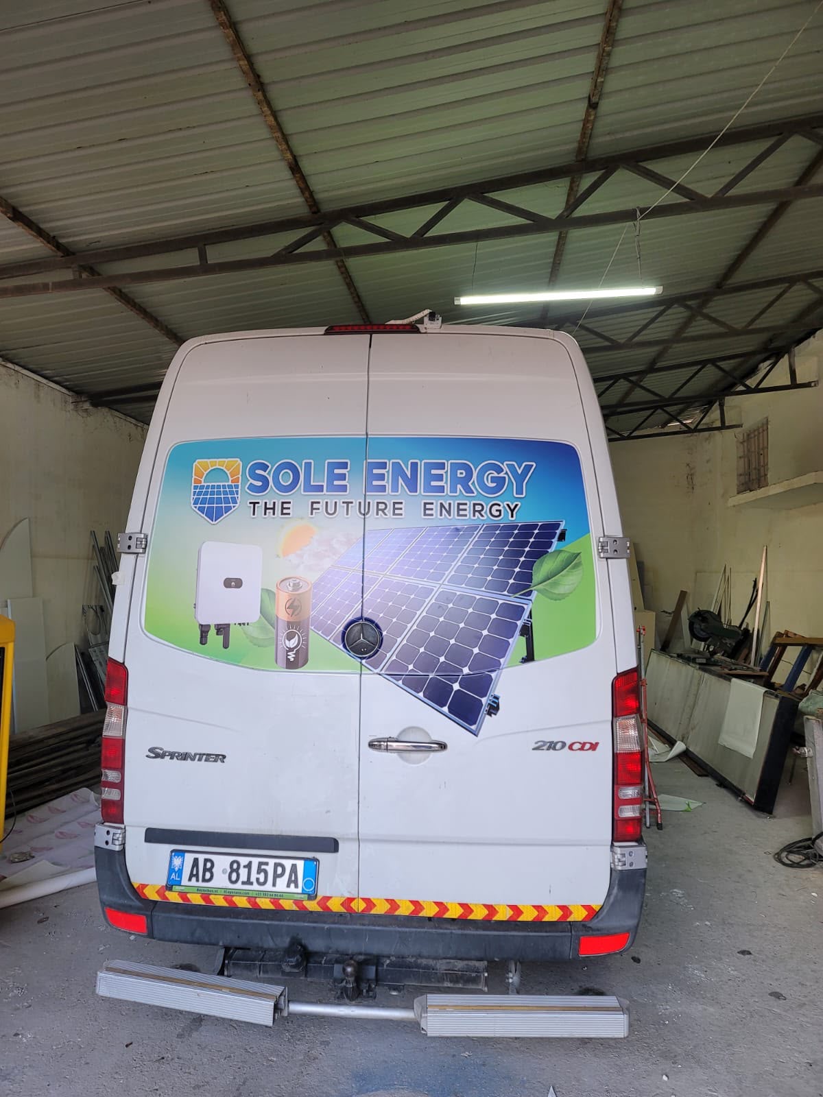Sprinter rear doors with a Sole Energy graphic: solar panels, an inverter and a battery