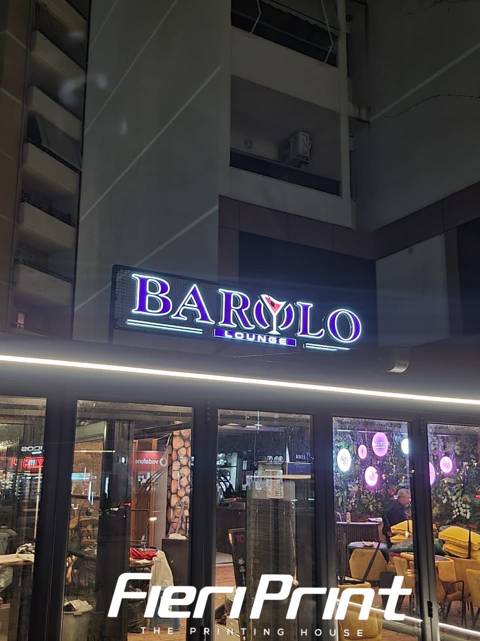 Glowing BAROLO Lounge 3D letters with a martini-glass motif at night