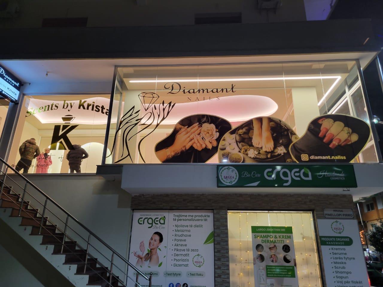 Two-storey facade at night with window graphics for Diamant Nails, Scents by Krista and Ergea Bio Care