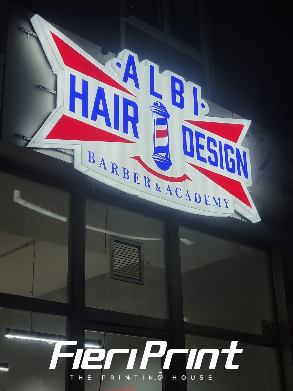 Illuminated Albi Hair Design barbershop lightbox at night