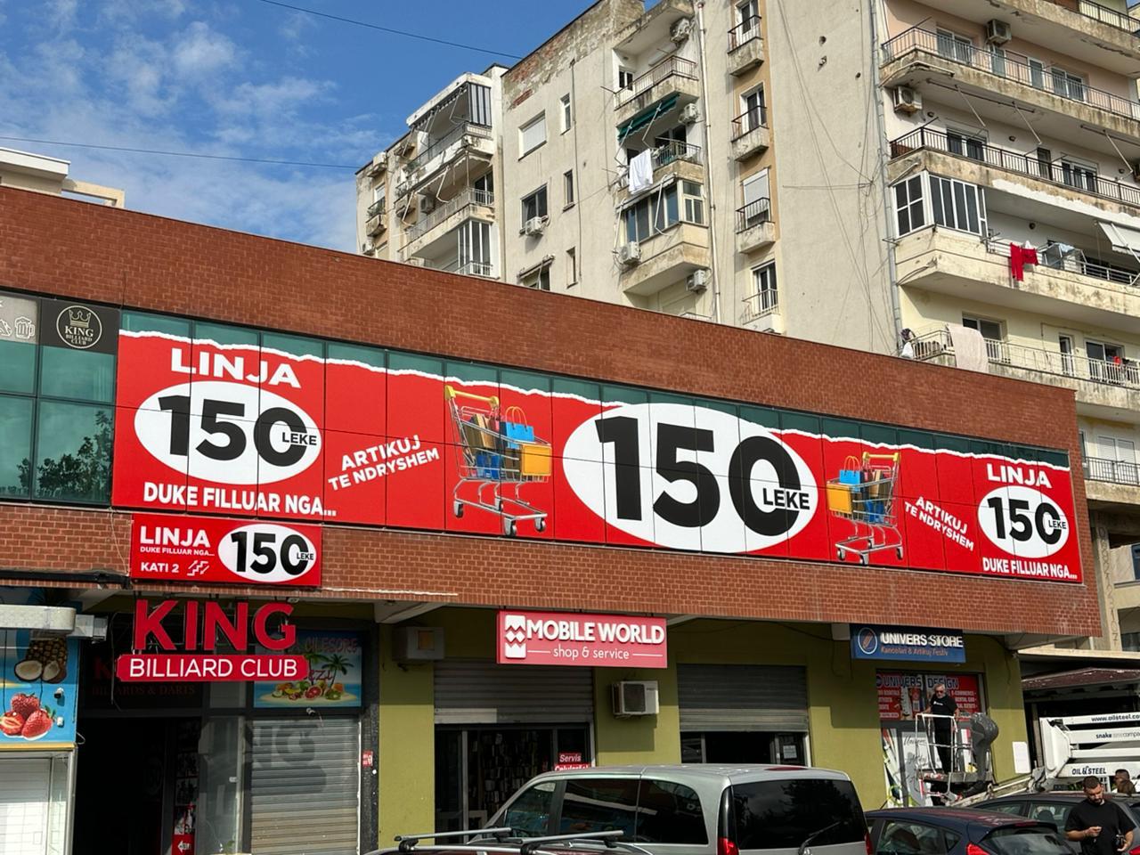 Red Linja 150 Leke panels with shopping-cart graphics along a brick facade, above the King Billiard Club and Mobile World signs