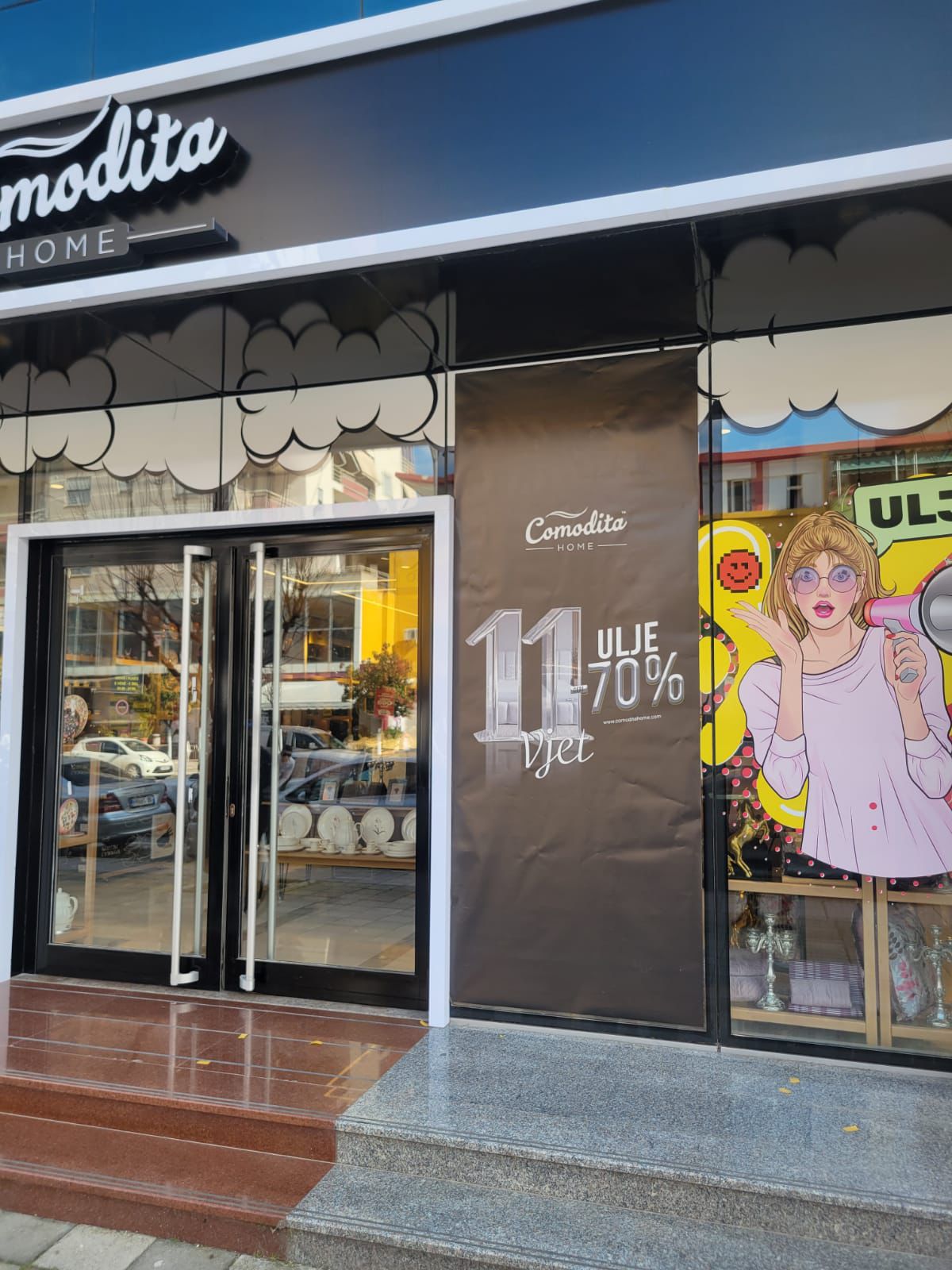Comodita Home facade with 3D letters, panel graphics and window posters for the anniversary sale