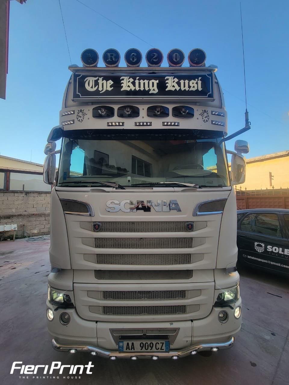 Scania R620 tractor with a black illuminated The King Kusi nameplate and R620 discs above the cab